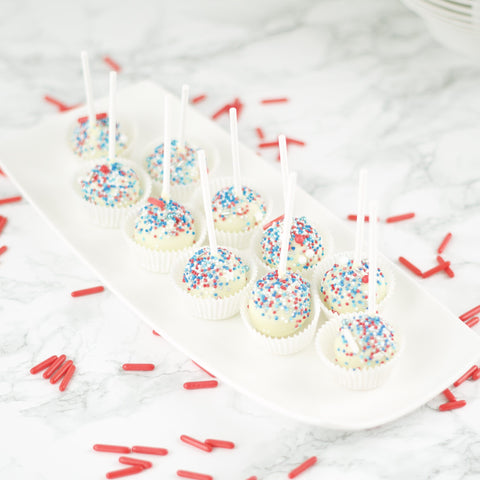 Witte cakepops met rood, wit en blauwe sprinkles